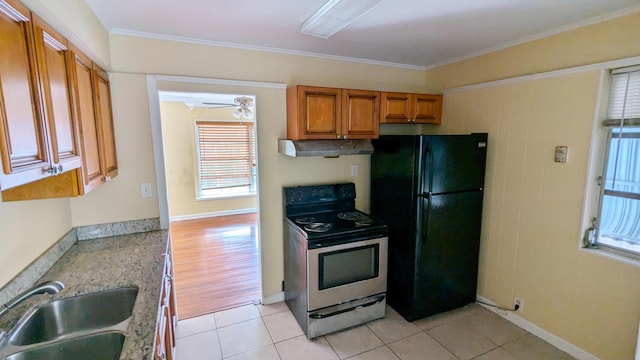 kitchen featuring black fridge, ornamental molding, sink, light hardwood / wood-style flooring, and stainless steel range with electric cooktop