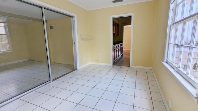 unfurnished bedroom featuring a closet and light tile patterned flooring