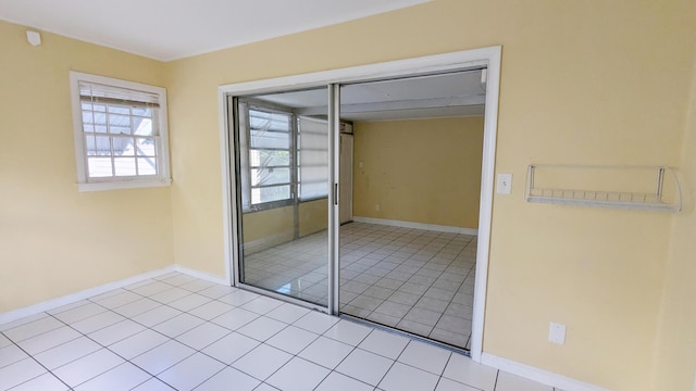 unfurnished bedroom with light tile patterned floors and a closet