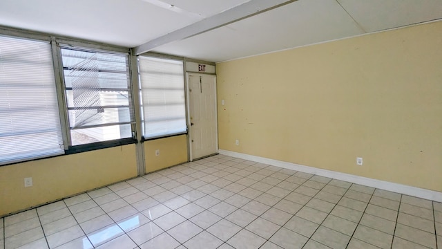 tiled empty room with beam ceiling