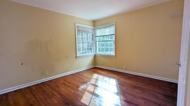 unfurnished room featuring dark wood-type flooring