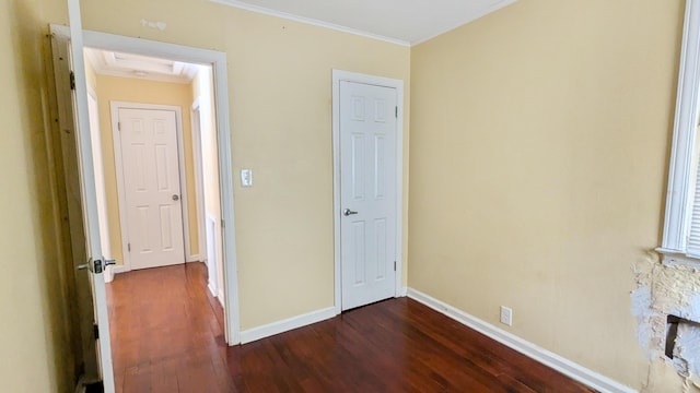 interior space with dark hardwood / wood-style floors and ornamental molding