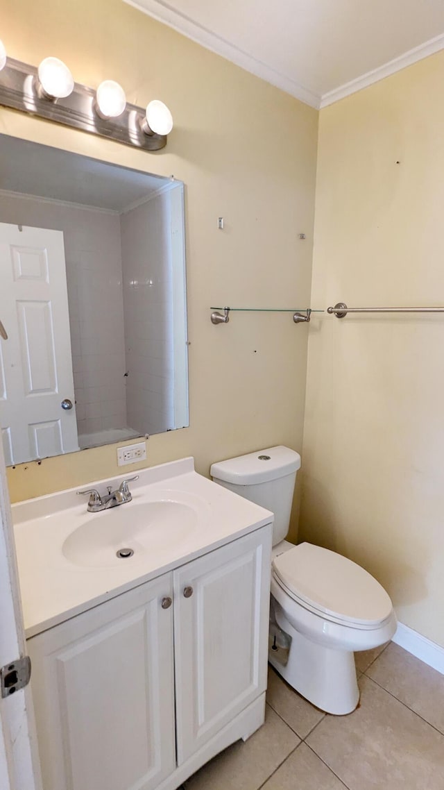 bathroom with tile patterned flooring, vanity, toilet, and crown molding