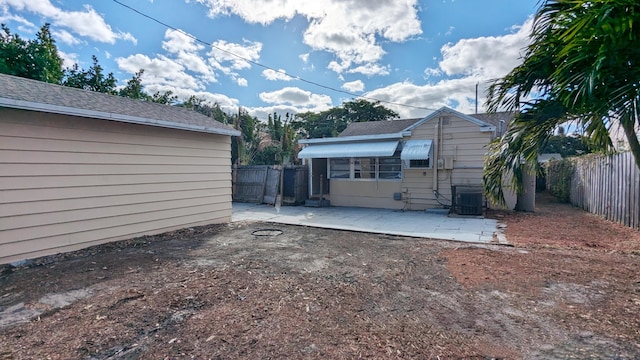 back of house with central AC and a patio