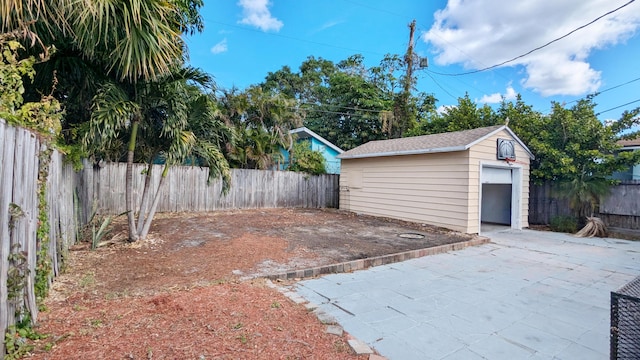 view of patio featuring an outbuilding and a garage