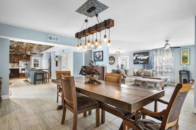 dining area featuring ceiling fan and light hardwood / wood-style floors