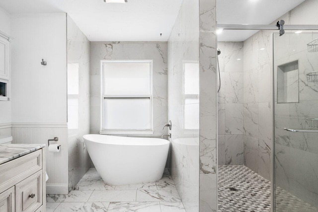 bathroom featuring vanity and shower with separate bathtub