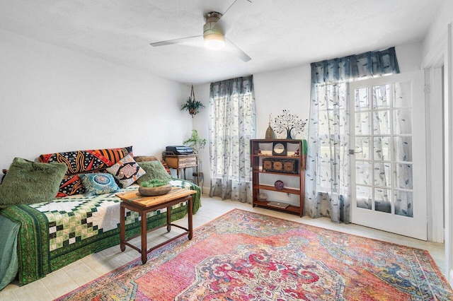 sitting room featuring ceiling fan, hardwood / wood-style floors, and a textured ceiling