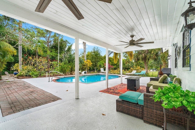 view of pool with outdoor lounge area, a patio, and ceiling fan