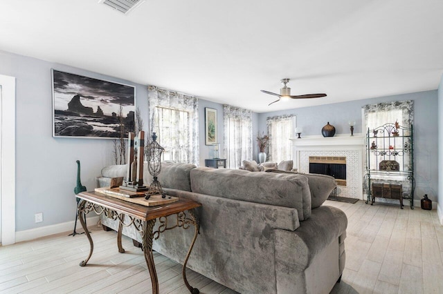 living room featuring ceiling fan and light wood-type flooring