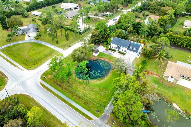 view of property's community with a yard and a water view