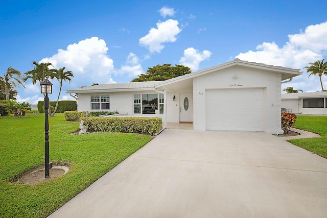 ranch-style house featuring a front lawn and a garage