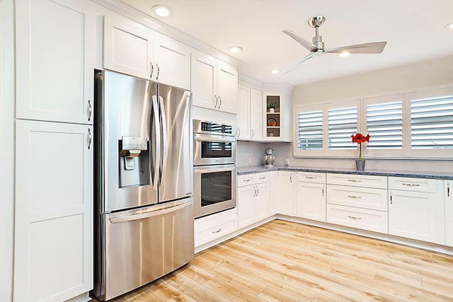 kitchen featuring white cabinets, stainless steel appliances, ceiling fan, and light hardwood / wood-style floors