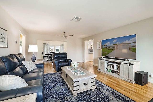 living room with hardwood / wood-style flooring and ceiling fan