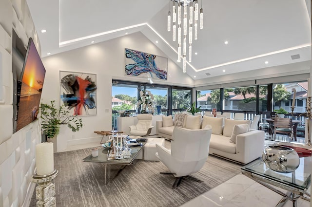 living room featuring high vaulted ceiling and a chandelier