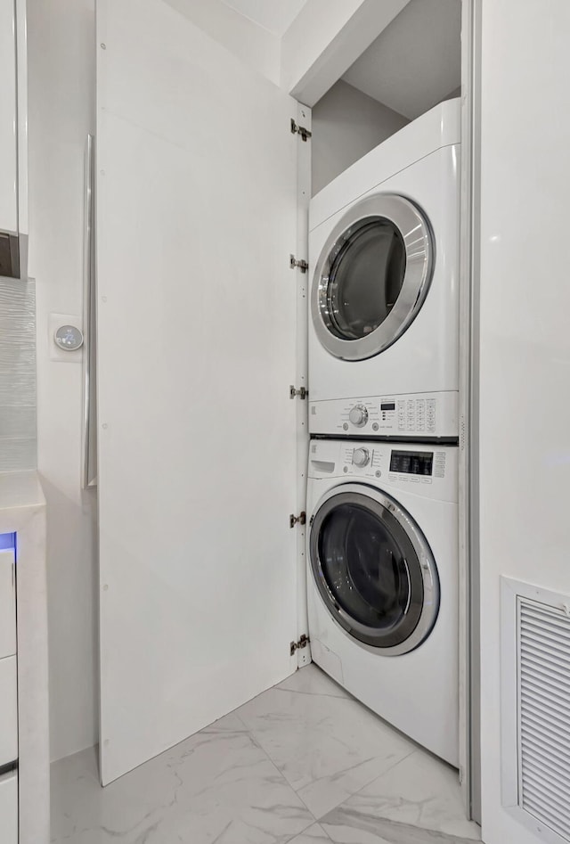 washroom featuring stacked washer and dryer