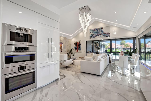 living room featuring a chandelier and high vaulted ceiling