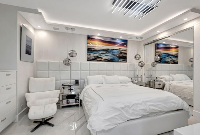 bedroom featuring tile walls and a tray ceiling