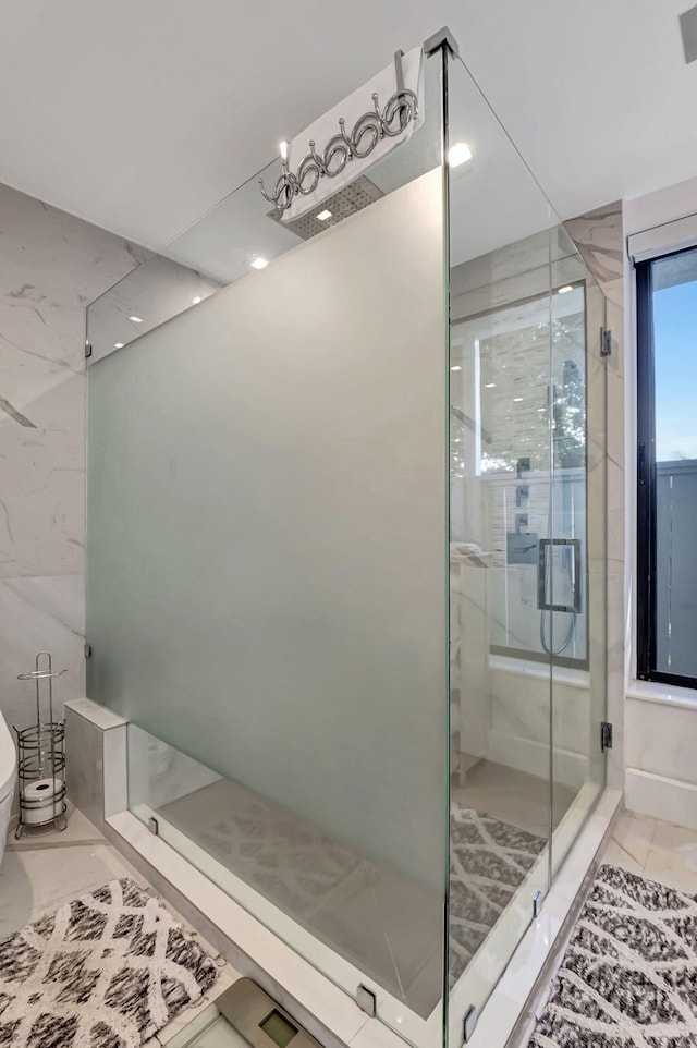 bathroom with tile patterned flooring, toilet, and an enclosed shower