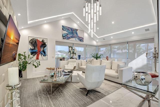 living room featuring a chandelier and high vaulted ceiling