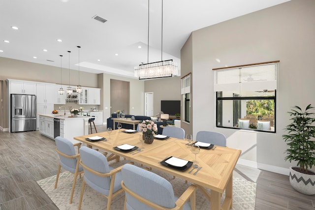 dining space with light wood-style floors, recessed lighting, visible vents, and baseboards