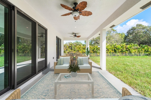 view of patio / terrace with fence, an outdoor living space, a ceiling fan, and outdoor dining space