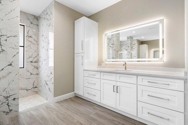 bathroom featuring vanity, hardwood / wood-style flooring, tile walls, and independent shower and bath