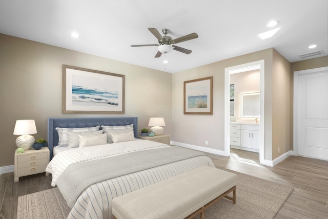 bedroom featuring light wood finished floors, baseboards, visible vents, and recessed lighting