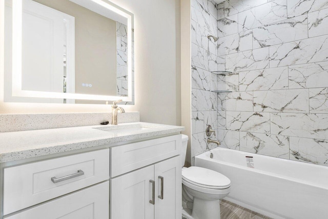 full bathroom featuring toilet, vanity, and tiled shower / bath combo