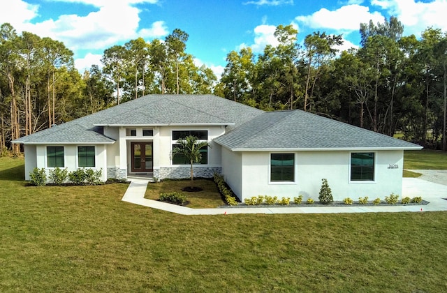 view of front of house with a shingled roof, a front yard, and french doors