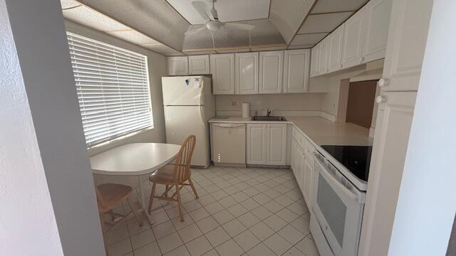 kitchen featuring ceiling fan, sink, white cabinets, and white appliances