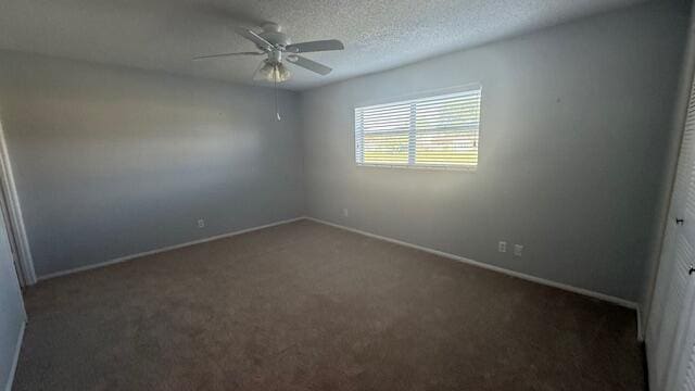 carpeted spare room with ceiling fan and a textured ceiling