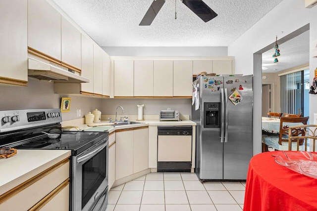 kitchen with sink, ceiling fan, a textured ceiling, light tile patterned flooring, and stainless steel appliances