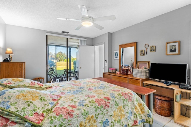 tiled bedroom with access to exterior, ceiling fan, and a textured ceiling