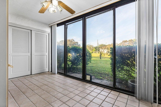 unfurnished sunroom with a wealth of natural light and ceiling fan