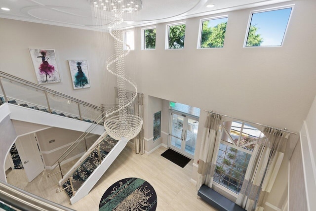 interior space with plenty of natural light, french doors, and an inviting chandelier