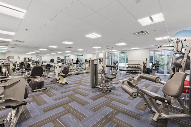 workout area featuring a drop ceiling and carpet