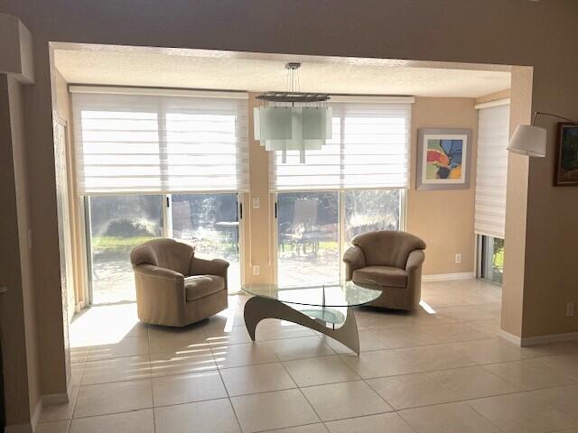 living area featuring plenty of natural light and light tile patterned flooring