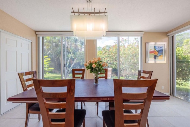 dining area with light tile patterned flooring and a textured ceiling