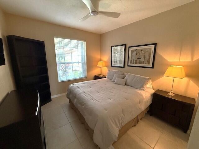 bedroom featuring ceiling fan and light tile patterned floors