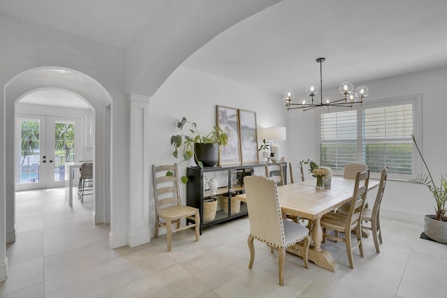 dining room with french doors, light tile patterned floors, and a notable chandelier