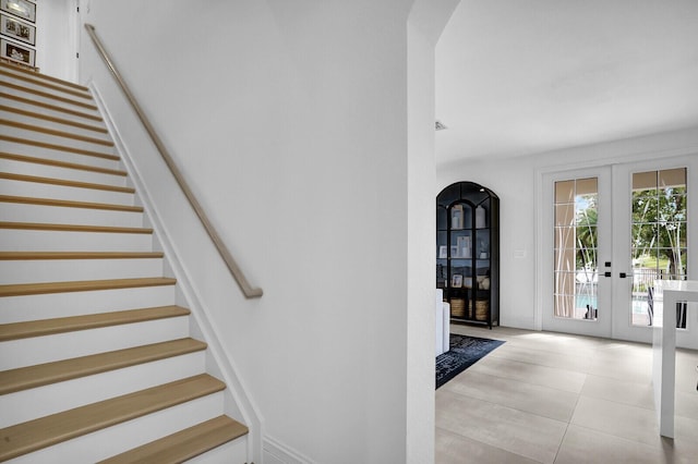 staircase with french doors