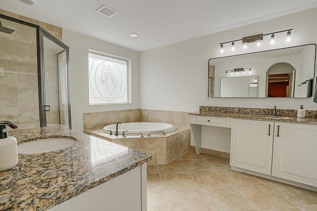 bathroom featuring tile patterned flooring, vanity, and separate shower and tub