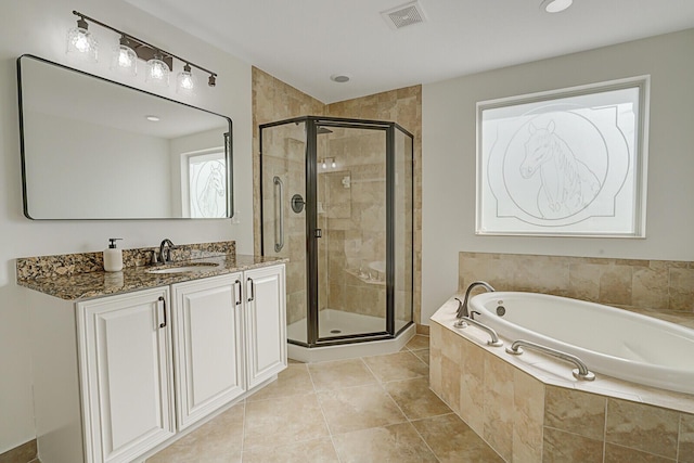 bathroom with tile patterned floors, vanity, and independent shower and bath