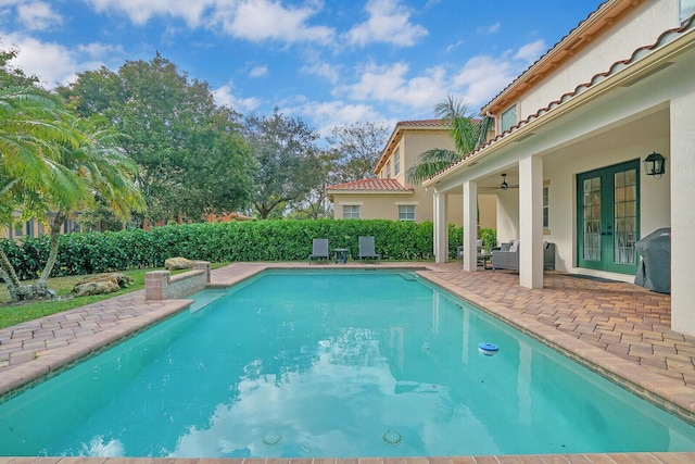 view of pool featuring a patio, an outdoor hangout area, ceiling fan, and grilling area