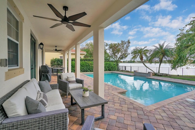 view of pool with an outdoor living space, a patio, ceiling fan, and a grill