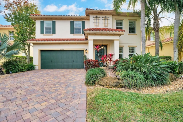 mediterranean / spanish-style house with a garage