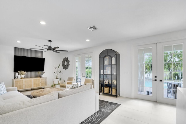 living room with ceiling fan and french doors