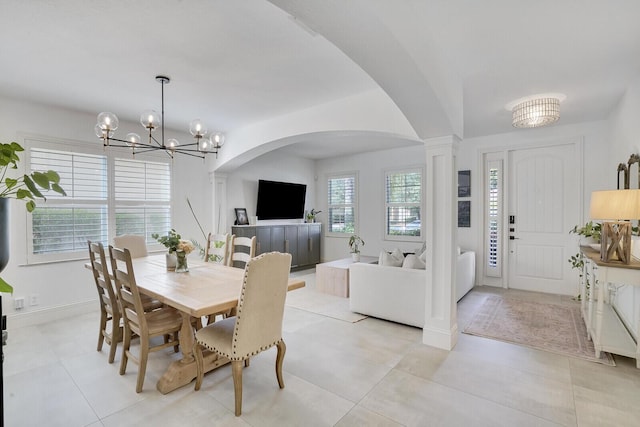 tiled dining area with a notable chandelier