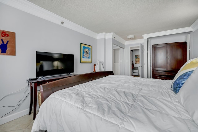 tiled bedroom with ornamental molding and a textured ceiling